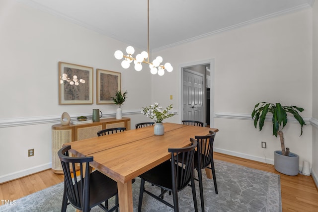 10721 Marabou Ct, Raleigh, NC 27614 - dining room featuring wood finished floors, crown molding, and a chandelier