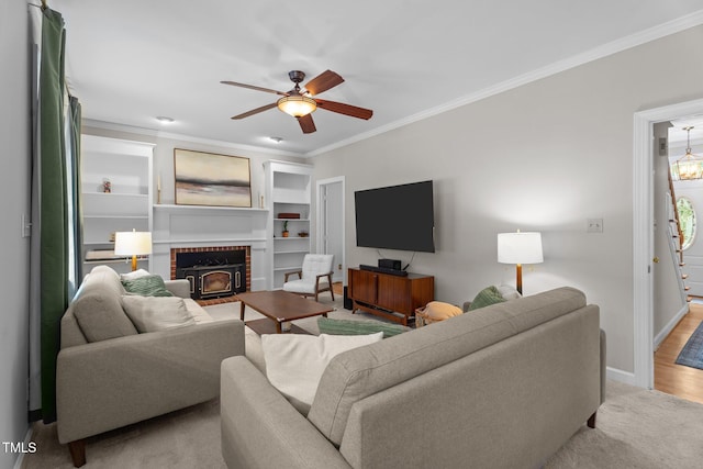 10721 Marabou Ct, Raleigh, NC 27614 - living room featuring ornamental molding, a ceiling fan, a brick fireplace, and built in shelves