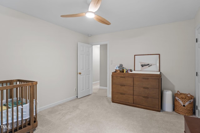 10721 Marabou Ct, Raleigh, NC 27614 - bedroom with light colored carpet, a crib, and a ceiling fan