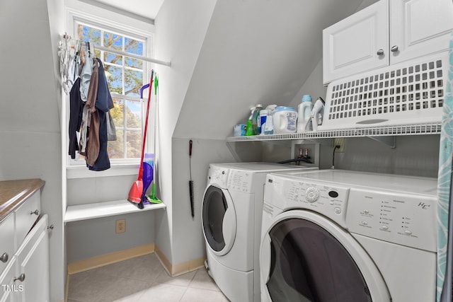 10721 Marabou Ct, Raleigh, NC 27614 - washroom with washer and clothes dryer, cabinet space, healthy amount of natural light, and light tile patterned flooring