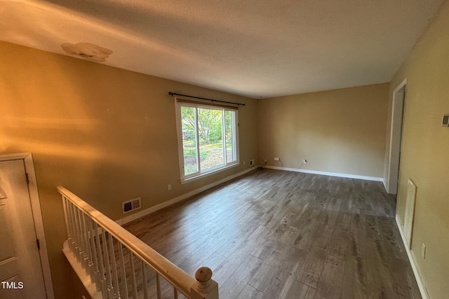 609 Sloan Dr, Cary, NC 27511 - spare room with dark wood-style flooring and baseboards