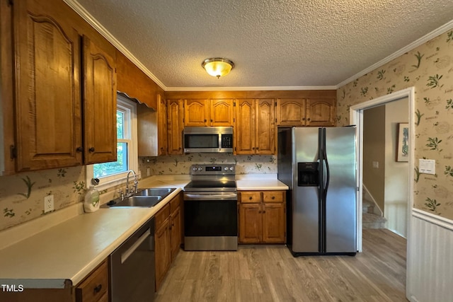 609 Sloan Dr, Cary, NC 27511 - kitchen featuring appliances with stainless steel finishes, brown cabinets, wallpapered walls, light wood finished floors, and light countertops