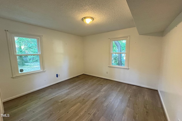 609 Sloan Dr, Cary, NC 27511 - unfurnished room featuring wood-type flooring and a textured ceiling
