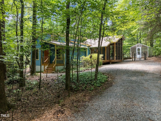 9709 Greenfield Rd, Chapel Hill, NC 27516 - view of front of property with a sunroom and a storage shed