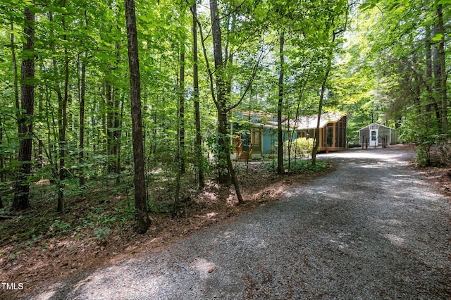 9709 Greenfield Rd, Chapel Hill, NC 27516 - view of front of home with gravel driveway and a forest view
