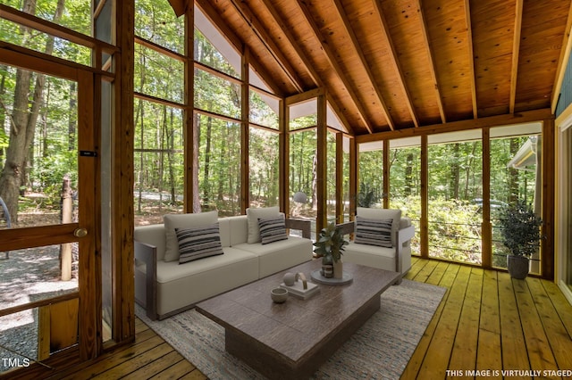 9709 Greenfield Rd, Chapel Hill, NC 27516 - sunroom with wood-type flooring, outdoor lounge area, healthy amount of natural light, a wall of windows, and high vaulted ceiling