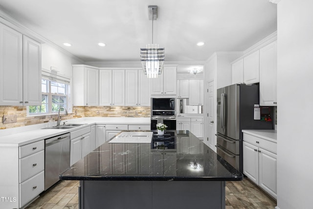 5125 Pinehall Wynd, Raleigh, NC 27604 - kitchen featuring stainless steel appliances, a kitchen island, white cabinets, wood finished floors, and crown molding