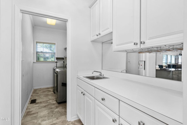 5125 Pinehall Wynd, Raleigh, NC 27604 - laundry room featuring washing machine and dryer and ornamental molding