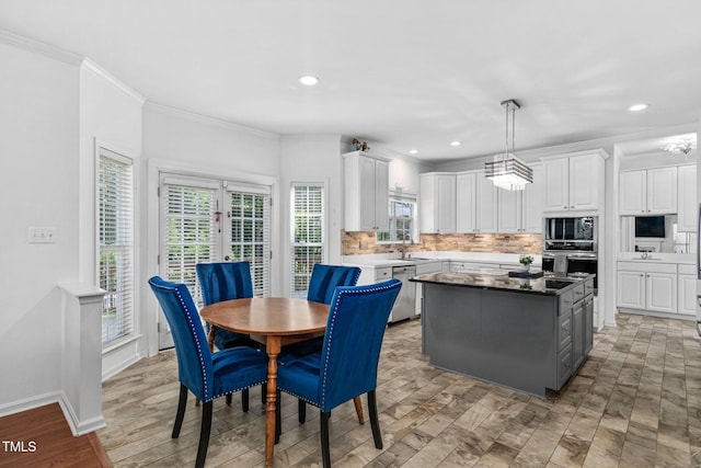 5125 Pinehall Wynd, Raleigh, NC 27604 - kitchen with appliances with stainless steel finishes, healthy amount of natural light, white cabinetry, crown molding, and recessed lighting
