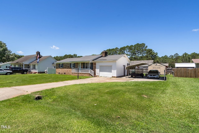 117 James Dr, Pine Level, NC 27568 - ranch-style home with a detached carport, concrete driveway, a chimney, brick siding, and an attached garage