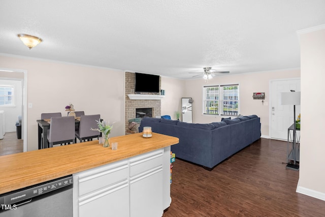 117 James Dr, Pine Level, NC 27568 - living room featuring ceiling fan, a brick fireplace, dark wood finished floors, crown molding, and a textured ceiling