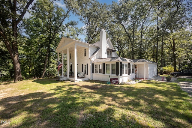 900 Beaman St, Clinton, NC 28328 - view of property exterior with a lawn, a sunroom, and a chimney