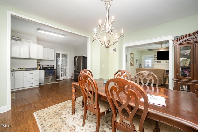 900 Beaman St, Clinton, NC 28328 - dining area featuring dark wood finished floors and a chandelier