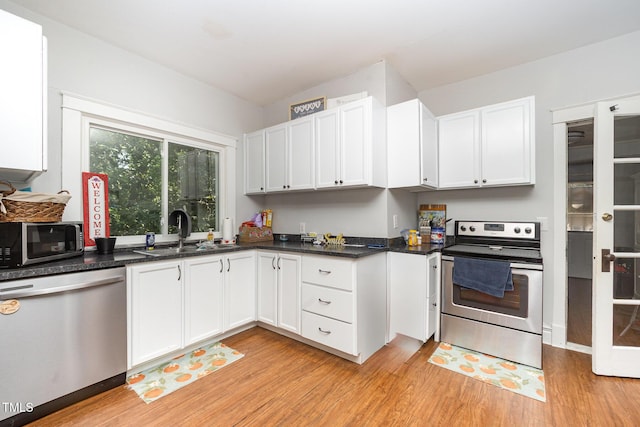 900 Beaman St, Clinton, NC 28328 - kitchen featuring appliances with stainless steel finishes, light wood-style flooring, and white cabinets