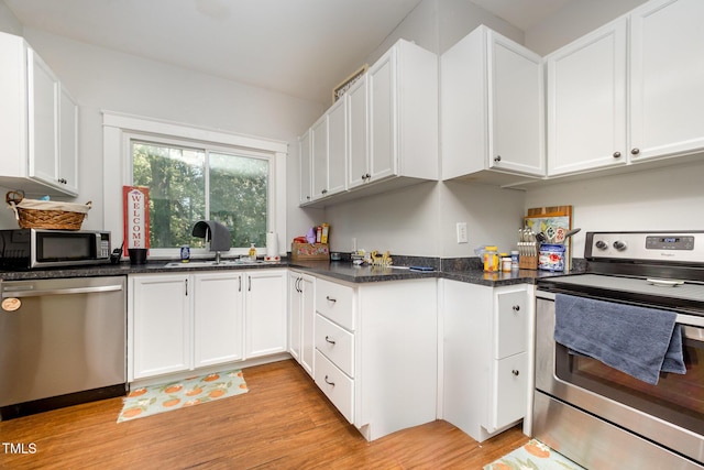 900 Beaman St, Clinton, NC 28328 - kitchen with stainless steel appliances, light wood finished floors, and white cabinets