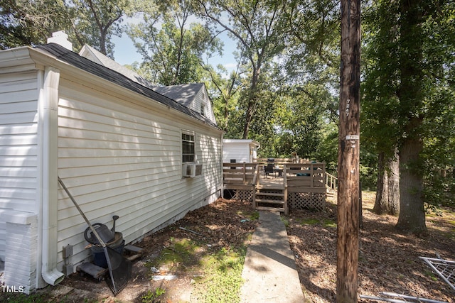 900 Beaman St, Clinton, NC 28328 - view of home's exterior featuring a wooden deck, a shingled roof, a chimney, and view of wooded area