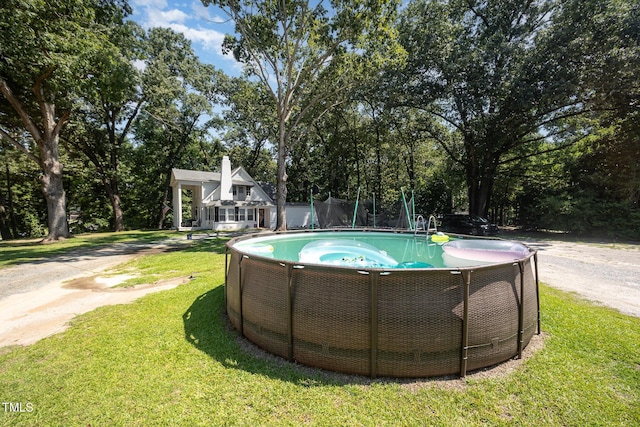900 Beaman St, Clinton, NC 28328 - view of swimming pool with a lawn and view of wooded area