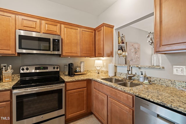 8221 Hempshire Pl Unit 101, Raleigh, NC 27613 - kitchen with stainless steel appliances, light stone countertops, and brown cabinets