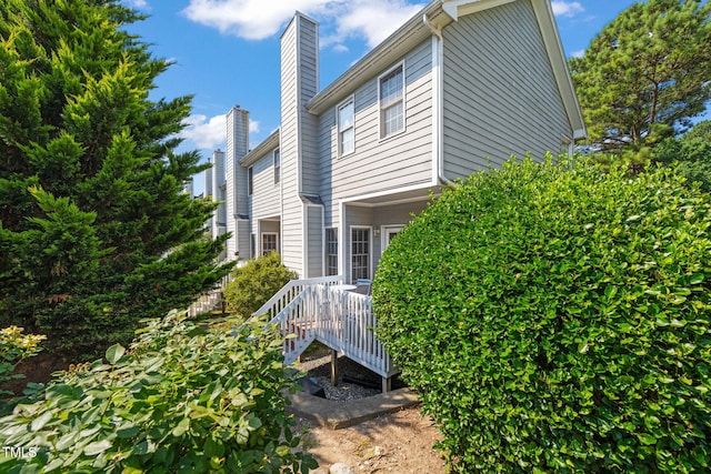 8221 Hempshire Pl Unit 101, Raleigh, NC 27613 - view of property exterior with a chimney