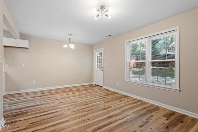 1611 Poole Rd, Raleigh, NC 27610 - unfurnished room with a chandelier and light wood finished floors