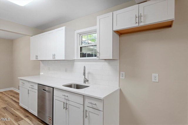 1611 Poole Rd, Raleigh, NC 27610 - kitchen featuring dishwasher, decorative backsplash, light wood-style floors, light countertops, and white cabinetry