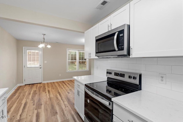 1611 Poole Rd, Raleigh, NC 27610 - kitchen with appliances with stainless steel finishes, white cabinets, tasteful backsplash, a chandelier, and light wood-type flooring