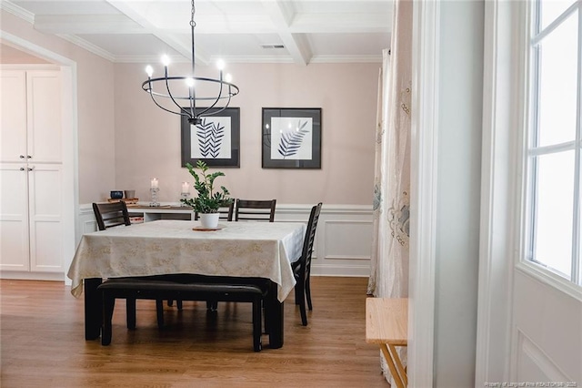 688 Townsend Rd, Raeford, NC 28376 - dining area featuring a chandelier, beamed ceiling, light wood-type flooring, ornamental molding, and a decorative wall