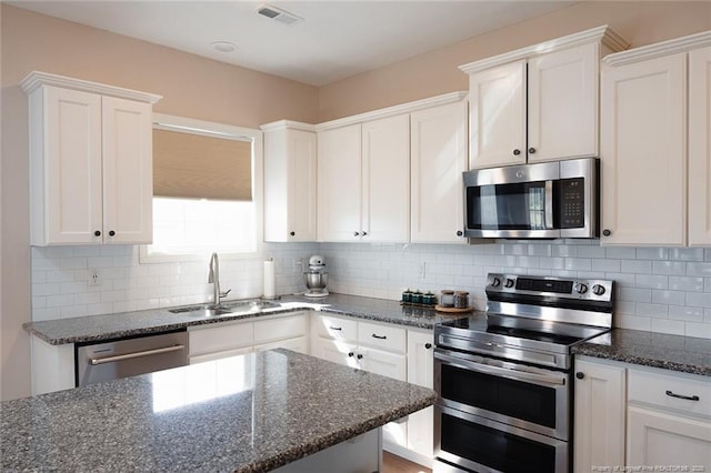 688 Townsend Rd, Raeford, NC 28376 - kitchen featuring stainless steel appliances, white cabinets, and decorative backsplash