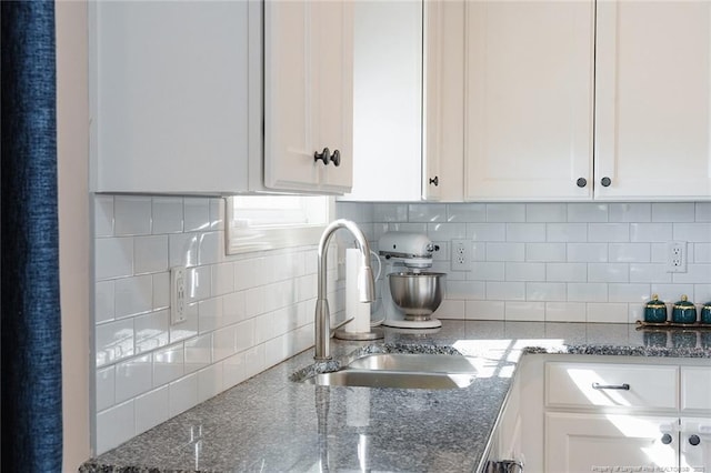688 Townsend Rd, Raeford, NC 28376 - kitchen featuring white cabinets, tasteful backsplash, and dark stone counters