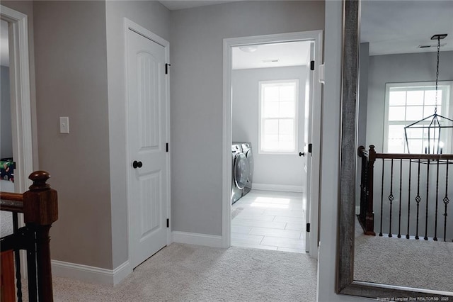 688 Townsend Rd, Raeford, NC 28376 - hall with washing machine and clothes dryer, carpet floors, and healthy amount of natural light
