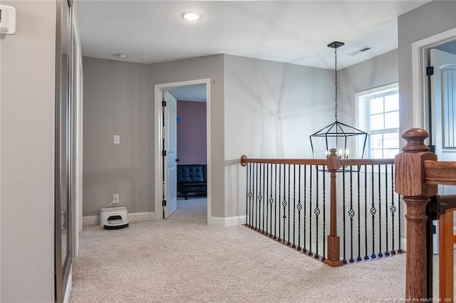 688 Townsend Rd, Raeford, NC 28376 - corridor with carpet floors and a chandelier