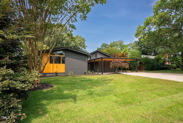 2129 Ridge Rd, Raleigh, NC 27607 - view of grassy yard featuring concrete driveway and an attached carport