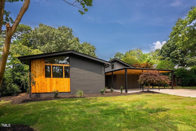 2129 Ridge Rd, Raleigh, NC 27607 - view of front of home with a front lawn, a carport, and brick siding