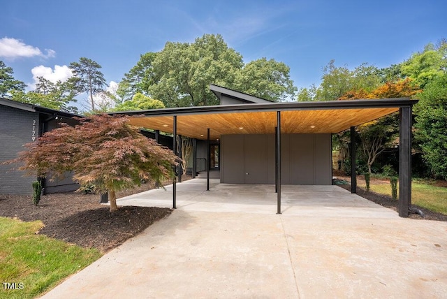 2129 Ridge Rd, Raleigh, NC 27607 - view of front of property featuring concrete driveway, board and batten siding, and an attached carport