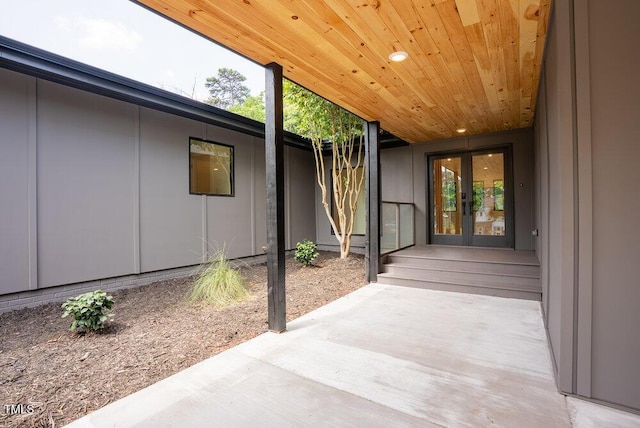 2129 Ridge Rd, Raleigh, NC 27607 - doorway to property featuring french doors, a patio area, and board and batten siding