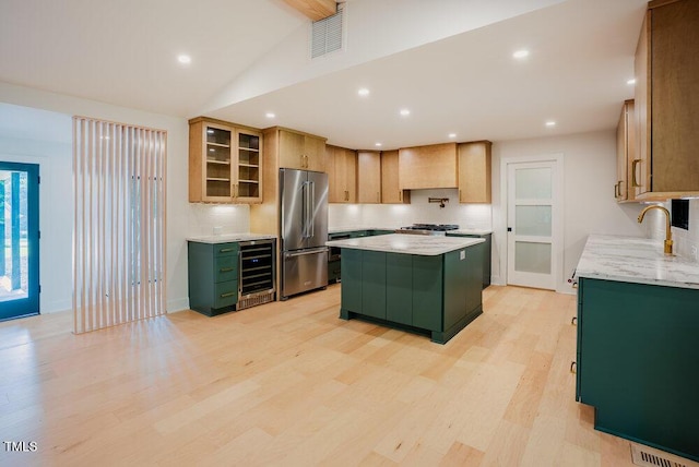 2129 Ridge Rd, Raleigh, NC 27607 - kitchen with high end refrigerator, green cabinetry, wine cooler, light wood-style floors, and a kitchen island