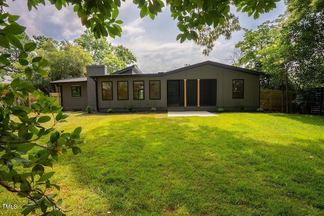 2129 Ridge Rd, Raleigh, NC 27607 - back of property with board and batten siding, a patio, and a chimney