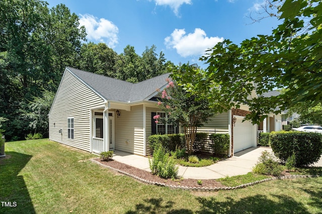 7807 Braefield Dr, Raleigh, NC 27616 - view of front facade with a front lawn, concrete driveway, an attached garage, and a shingled roof