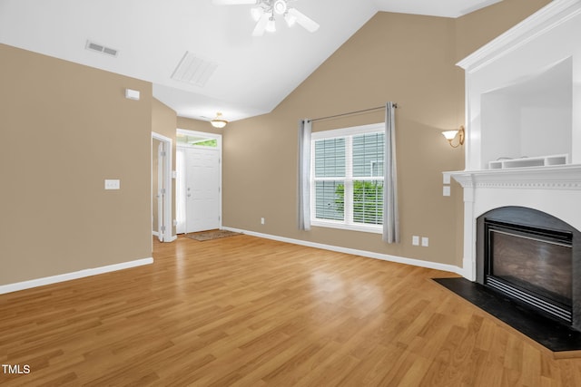 7807 Braefield Dr, Raleigh, NC 27616 - unfurnished living room featuring healthy amount of natural light, light wood-style floors, a fireplace with flush hearth, ceiling fan, and high vaulted ceiling
