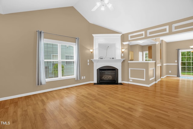 7807 Braefield Dr, Raleigh, NC 27616 - unfurnished living room with light wood-style floors, a fireplace with flush hearth, ceiling fan, and vaulted ceiling