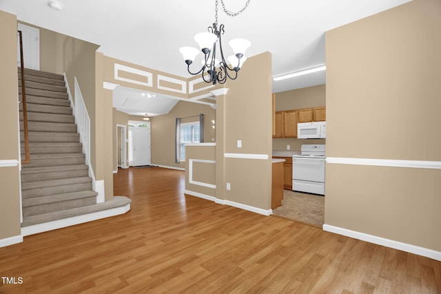 7807 Braefield Dr, Raleigh, NC 27616 - kitchen featuring white appliances, light wood-style floors, a chandelier, and light countertops