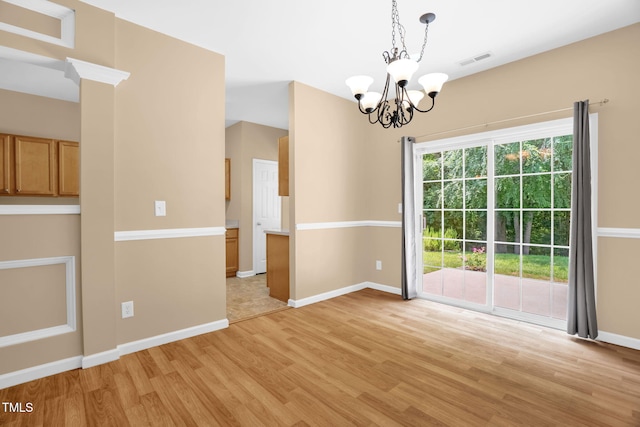7807 Braefield Dr, Raleigh, NC 27616 - unfurnished dining area with a chandelier and light wood-style flooring