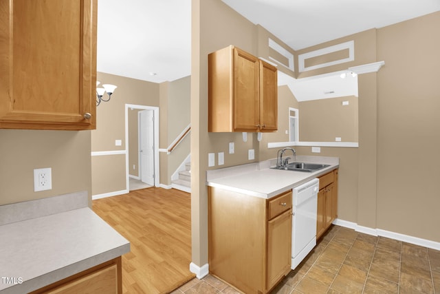 7807 Braefield Dr, Raleigh, NC 27616 - kitchen featuring white dishwasher, light countertops, and a chandelier