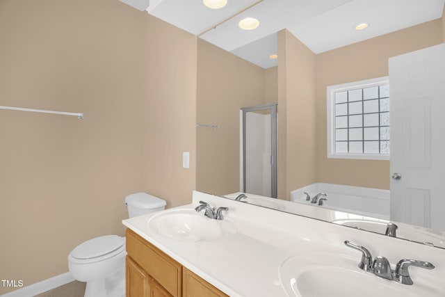 7807 Braefield Dr, Raleigh, NC 27616 - bathroom featuring a garden tub, double vanity, a shower stall, and recessed lighting