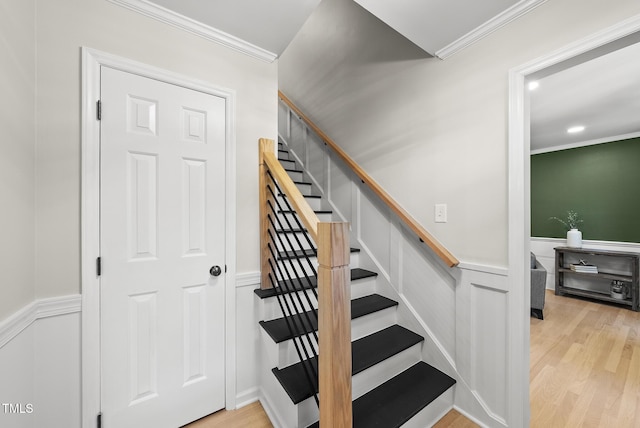 2704 Farnborough Rd, Raleigh, NC 27613 - stairs featuring a wainscoted wall, crown molding, wood finished floors, and a decorative wall