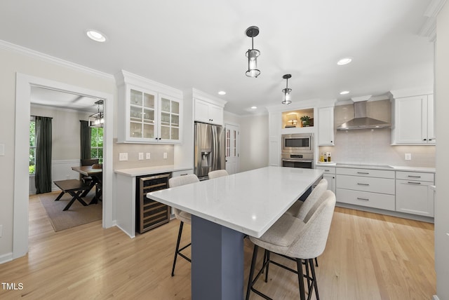 2704 Farnborough Rd, Raleigh, NC 27613 - kitchen with wall chimney range hood, appliances with stainless steel finishes, wine cooler, crown molding, and a kitchen breakfast bar