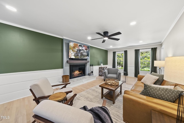 2704 Farnborough Rd, Raleigh, NC 27613 - living area featuring ornamental molding, ceiling fan, a glass covered fireplace, wood finished floors, and recessed lighting