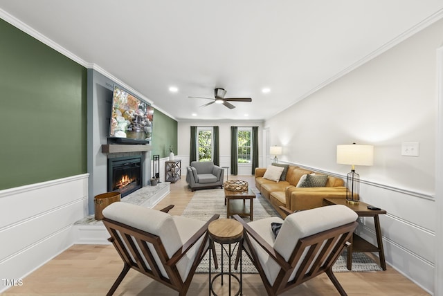 2704 Farnborough Rd, Raleigh, NC 27613 - living room featuring a large fireplace, ornamental molding, ceiling fan, light wood-type flooring, and recessed lighting