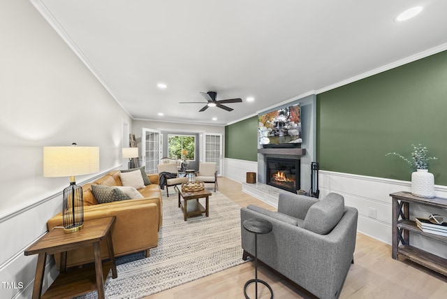 2704 Farnborough Rd, Raleigh, NC 27613 - living room with crown molding, a glass covered fireplace, ceiling fan, recessed lighting, and wainscoting
