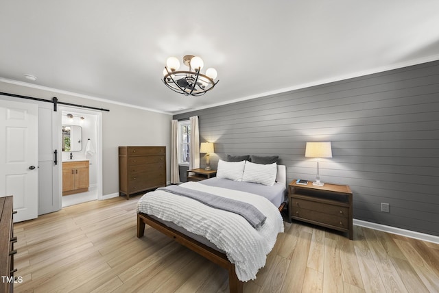 2704 Farnborough Rd, Raleigh, NC 27613 - bedroom with a chandelier, light wood finished floors, a barn door, crown molding, and ensuite bath